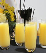 Image of orange juice sitting in glasses on a table at a funeral reception